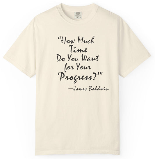Beige t-shirt with black text quote by James Baldwin on a white background