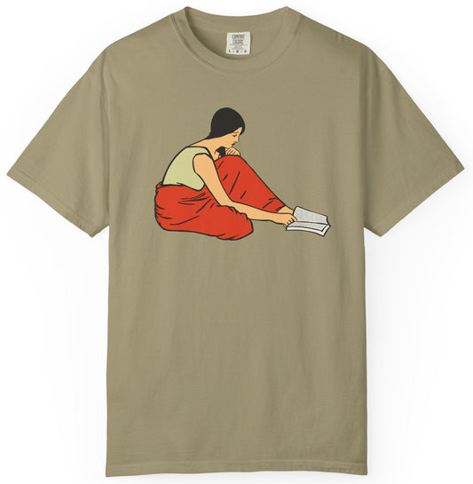 T-shirt of a graphic of woman reading a book on the floor.