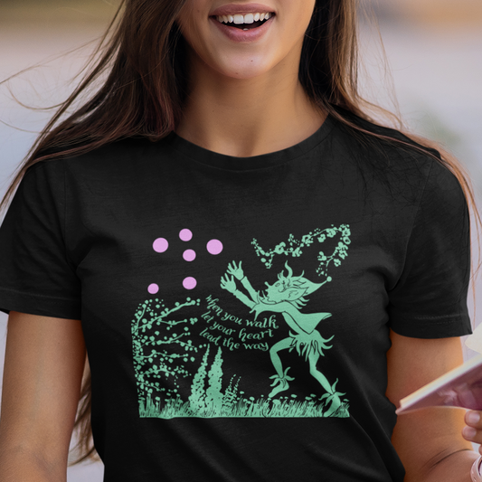 t-shirt with a pixie in a garden chasing bubbles graphic and 'when you walk let your heart lead the way' text lyrics from 'Alfie'