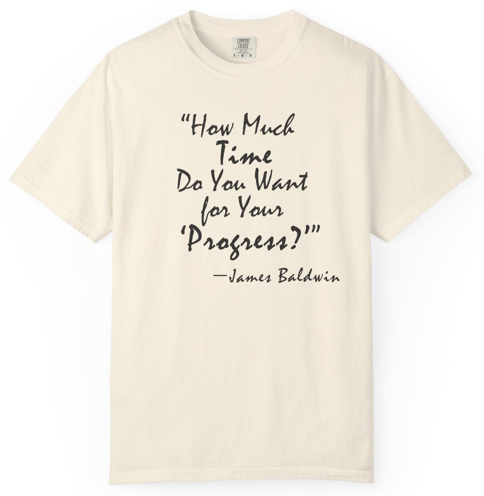 Beige t-shirt with black text quote by James Baldwin on a white background