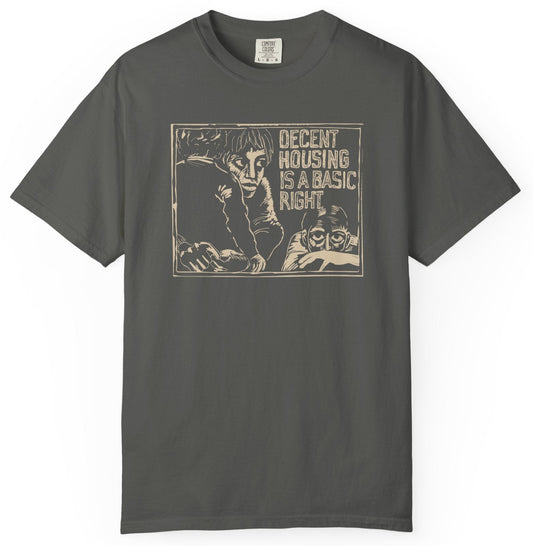T-shirt with graphic of a poor family and 'decent housing is a basic right' text