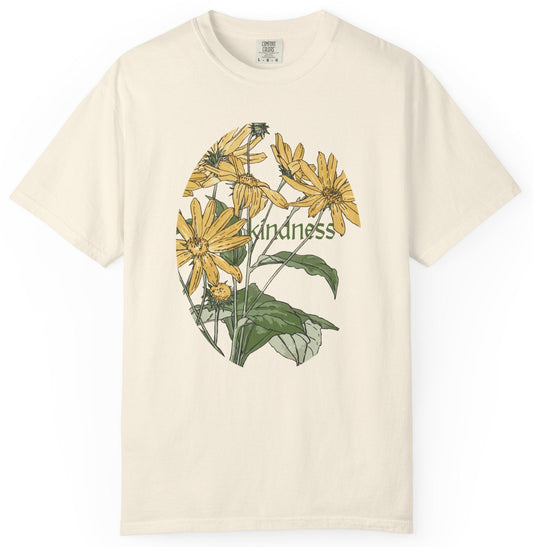 Beige t-shirt with yellow flowers and the word 'kindness' on a white background