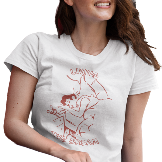 Woman wearing a white t-shirt with a red graphic and text 'Living the Dream'.