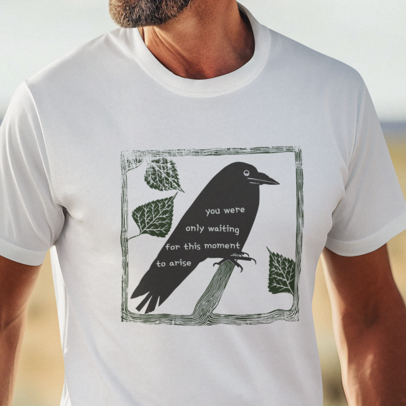 T-shirt with graphic image of a black bird on a perch with text of the Beatles' Blackbird lyrics.